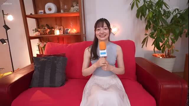 Tamura Kana ex-anchor smiles with mic on red sofa, JAV tease
