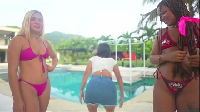 Three women in micro bikinis posing by the pool at GGMansion