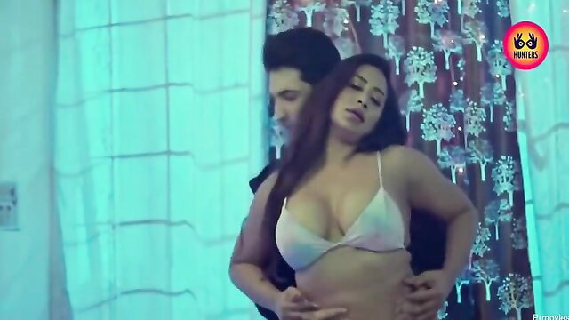 Hot Indian busty babe in white bra embraced by hunk in steamy bedroom scene