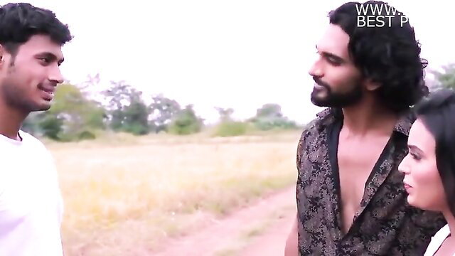 Indian couple with friend outdoors in field, flirty smiles