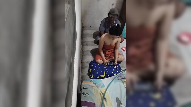 Indonesian masseur gropes petite Asian girl in orange dress on stairs