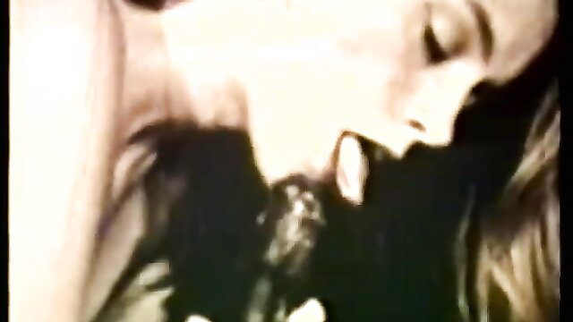 Vintage blonde bombshell deepthroating cock in O.Z. Films classic XXX