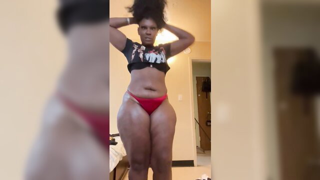 Thick black babe in red thong and crop top poses sexy