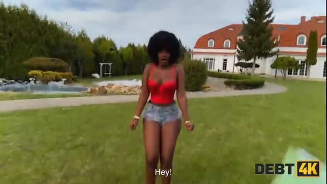 Black woman in red top and denim shorts on lawn, Debt 4K video thumbnail