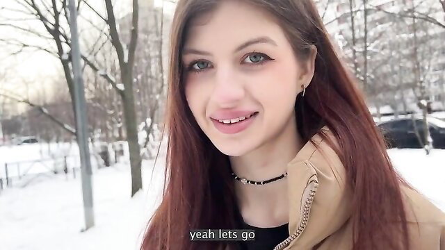 Lina Migurtt smiling outdoors in winter coat, red hair beauty
