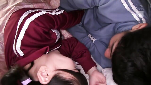 Cute Japanese girl and guy cuddling asleep in matching tracksuits JAV thumbnail