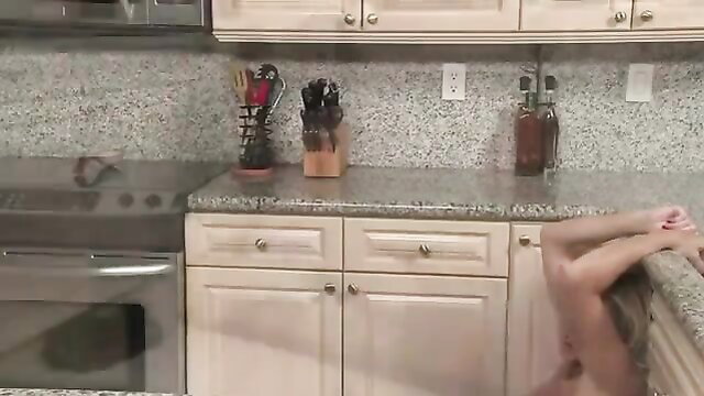 Golden-haired woman having sex on the kitchen counter