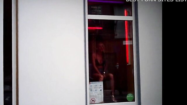 Blonde hooker in red light window Antwerp redlight district