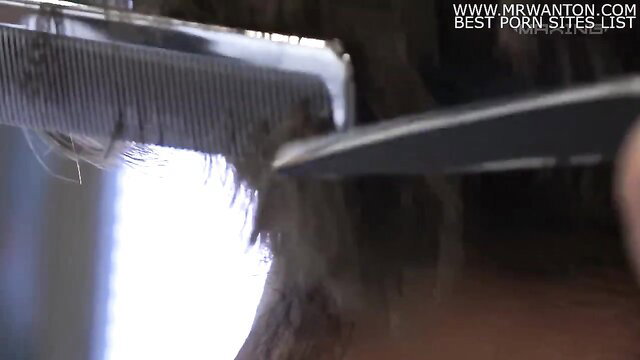 Asian woman getting haircut with comb and scissors closeup