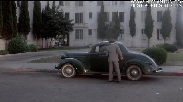 Dixie Ray Hollywood Star remastered: suited man by vintage green car outside mansion