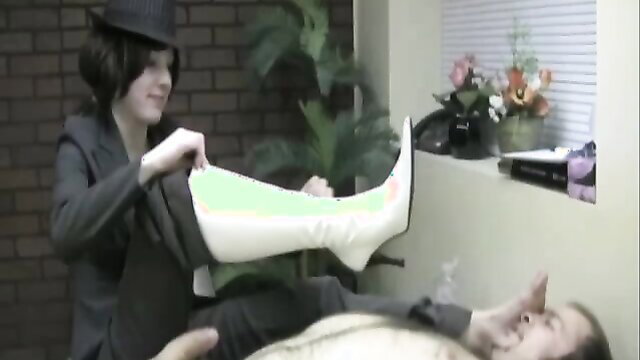 Mean boss Miss Samantha fits white boot cast on man's leg in femdom scene