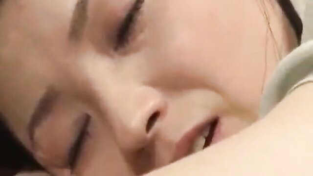 Asian stepmom eyes closed in ecstasy masturbating to JAV porn