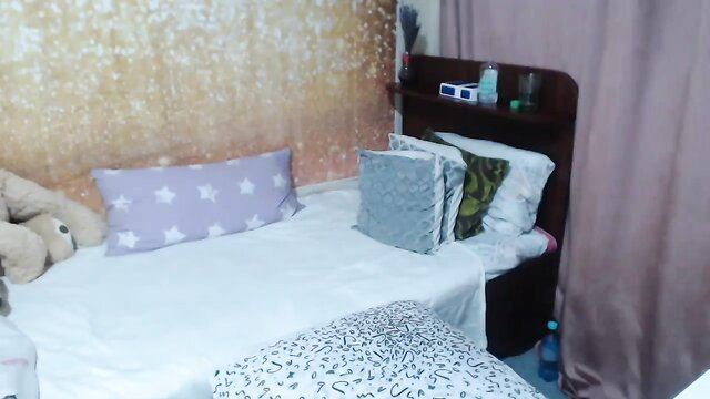 EmmaSexy amateur bedroom tease on bed with pillows and teddy bears
