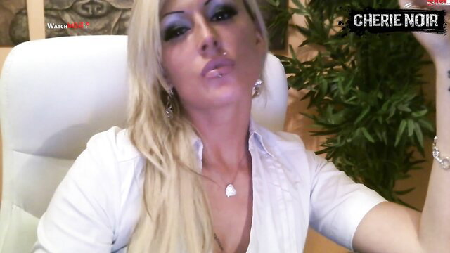 Blonde IsaVanGold in white blouse, seductive femdom gaze