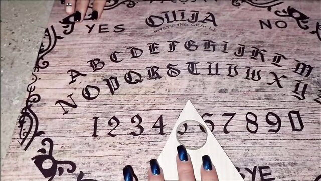 Martina's Ouija board hands with black nails in abandoned house
