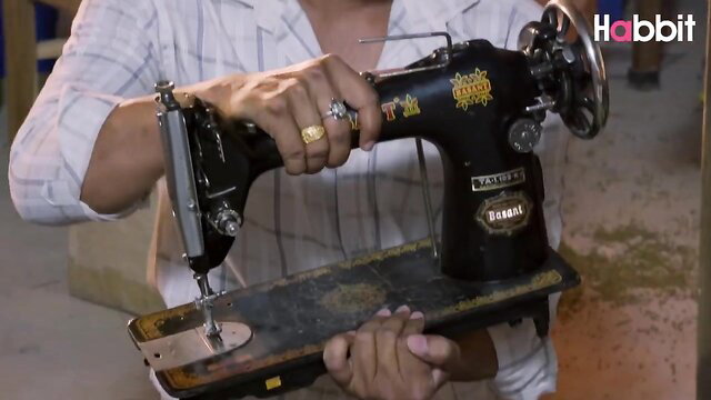 Curvy Indian tailor with big tits holds vintage sewing machine