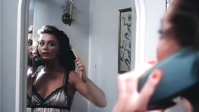 Anna Ventura in lingerie brushing hair in mirror, Bad Girls 1981