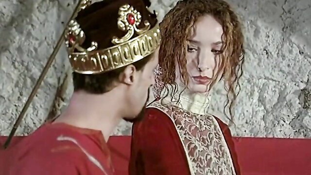 Sexy redhead in red lace dress with crowned king in Robin Hood adult parody