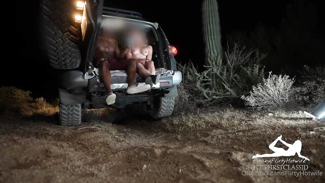 Hot couple fucking outdoors on Jeep tailgate at night in desert