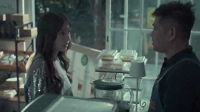 Asian beauty Aliya in sexy dress chats with barista Christy at cafe counter