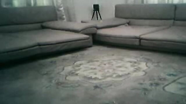 Bangladeshi prostitute in empty room on gray couches