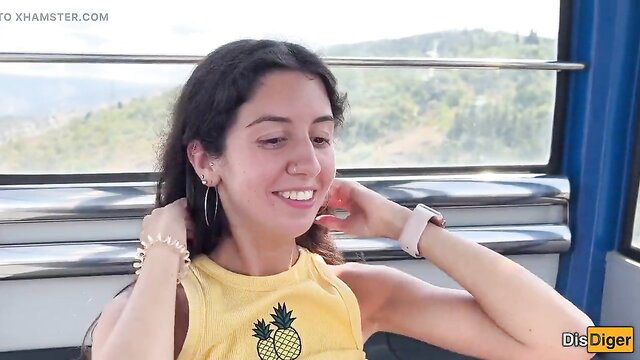 Smiling brunette MILF in yellow pineapple tank top on Ferris wheel