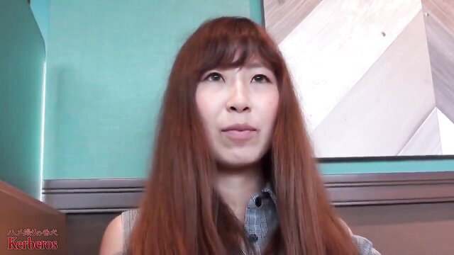 Kyoko Mikami with long brown bangs in teal room interview
