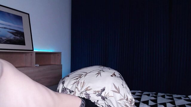 Alfie Evans alluring gay amateur on bed in lingerie, pale legs teasing