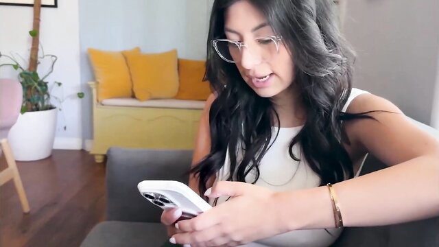 Sexy busty nerdy brunette Latina chick with glasses on phone