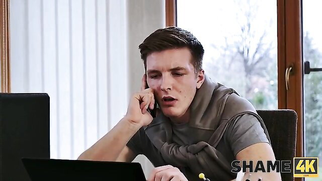 Handsome young man on phone call at desk in She Had To Do It