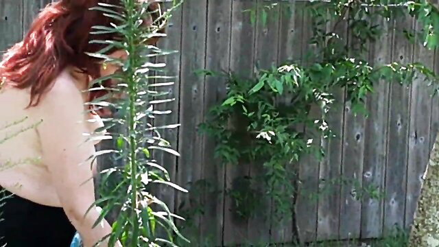 Hotwife Steffi nude gardening, topless redhead bends over in backyard