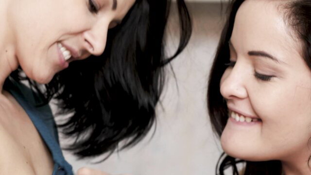 Cindy Hope closeup smile with brunette friend in teasing pose