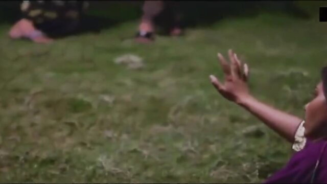 Indian woman in purple saree reaching out on grass in Zakham Episode 3
