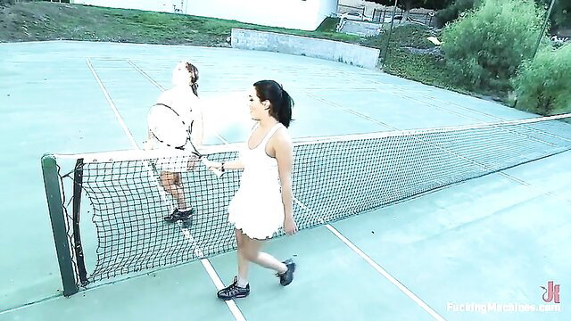 Charley in white dress on tennis court with Fucking Machines toy