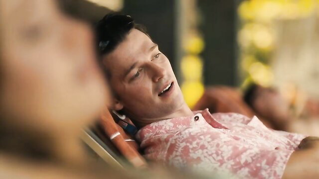 Tom Holland relaxing in pink shirt, hot White Lotus S3 scene