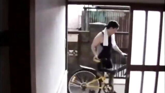 Muscular Asian man with towel exits room with bike in JAV milf scene