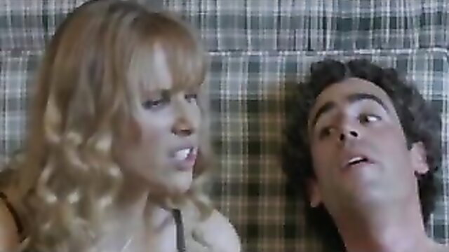 Blonde babe with bangs gives handjob to curly-haired guy on plaid sheets