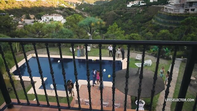 Pool party with sexy women in dresses by luxury villa balcony