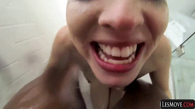 Closeup POV of smiling Asian woman grinning in interracial lesbo shower tease