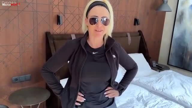 Blonde MILF Daynia in tight Nike tracksuit, sexy hotel pose