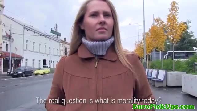 Blonde Euro girl-next-door in coat ponders morality on street