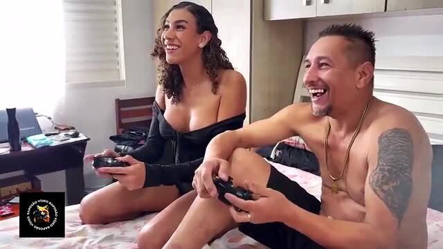 Raposao young trans in lingerie gaming with shirtless uncle on bed