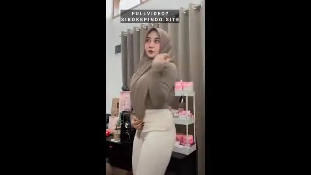 Indonesian hijab girl in tight sweater and pants poses sexy