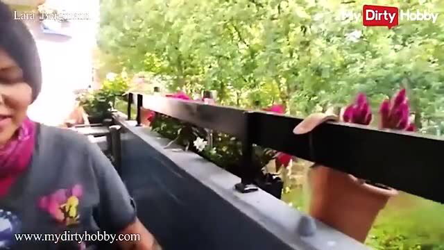 Lara Bergmann teases on balcony in tight tee, hot outdoor view