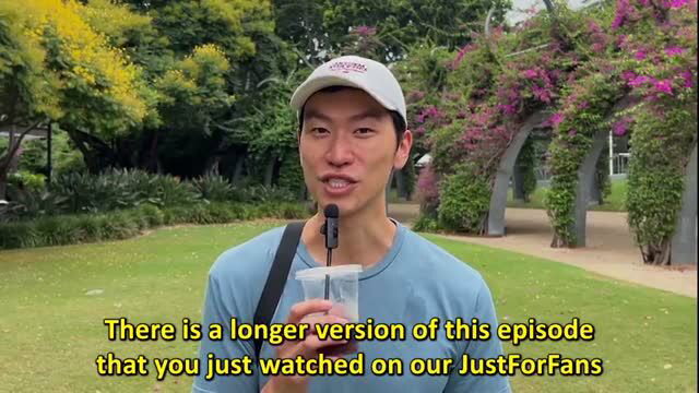 JoshyAndLocky in blue shirt outdoors holding drink with black cap