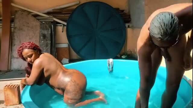 Ebony woman and muscular man in pool, explicit ass play scene