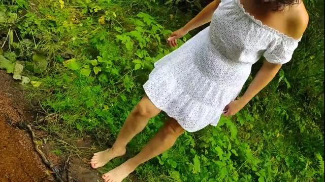 Woman in sheer white dress flashes ass in woods no panties