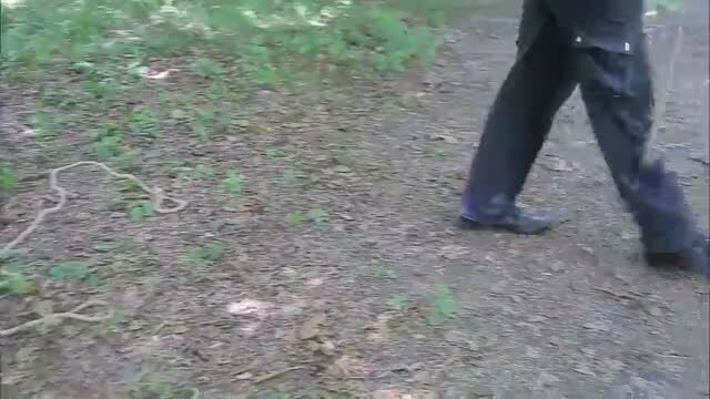 Luna T. walking outdoors in black outfit on forest path
